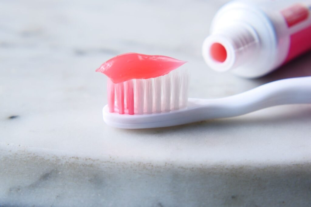 Toothbrush with whitening toothpaste on a bathroom counter