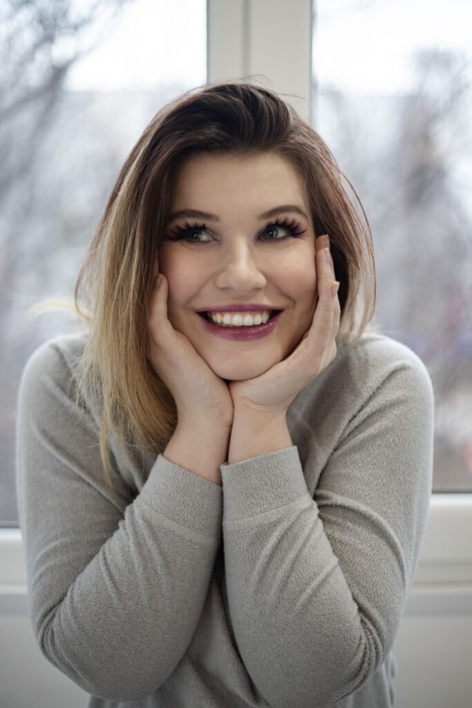 Woman checking her smile after using a teeth whitening pen