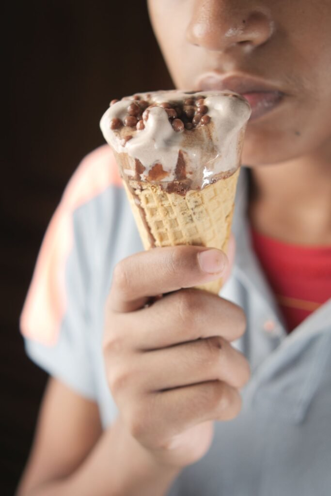 Person eating a melting ice cream cone